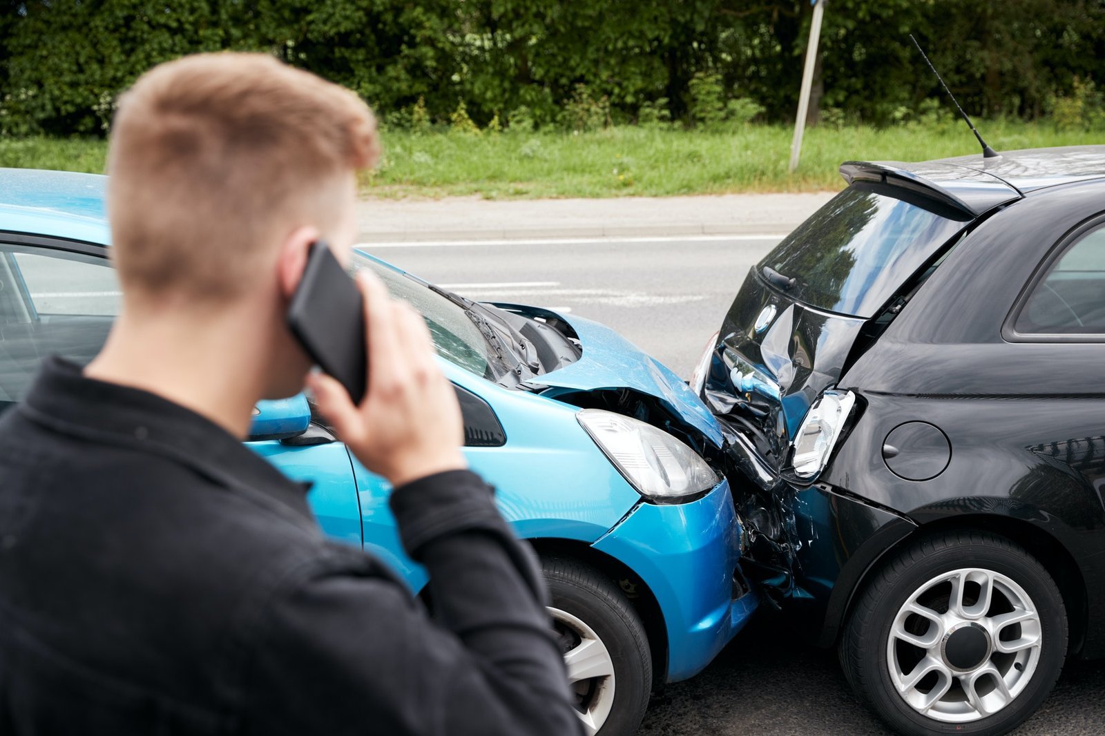 young-male-motorist-involved-in-car-accident-calling-insurance-company-or-recovery-service.jpg Affordable auto insurance crash protection services